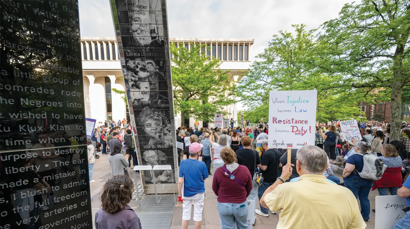 OTC_May Day March.jpg Marchers hold signs at a rally for May Day at the Fountain of Freedom