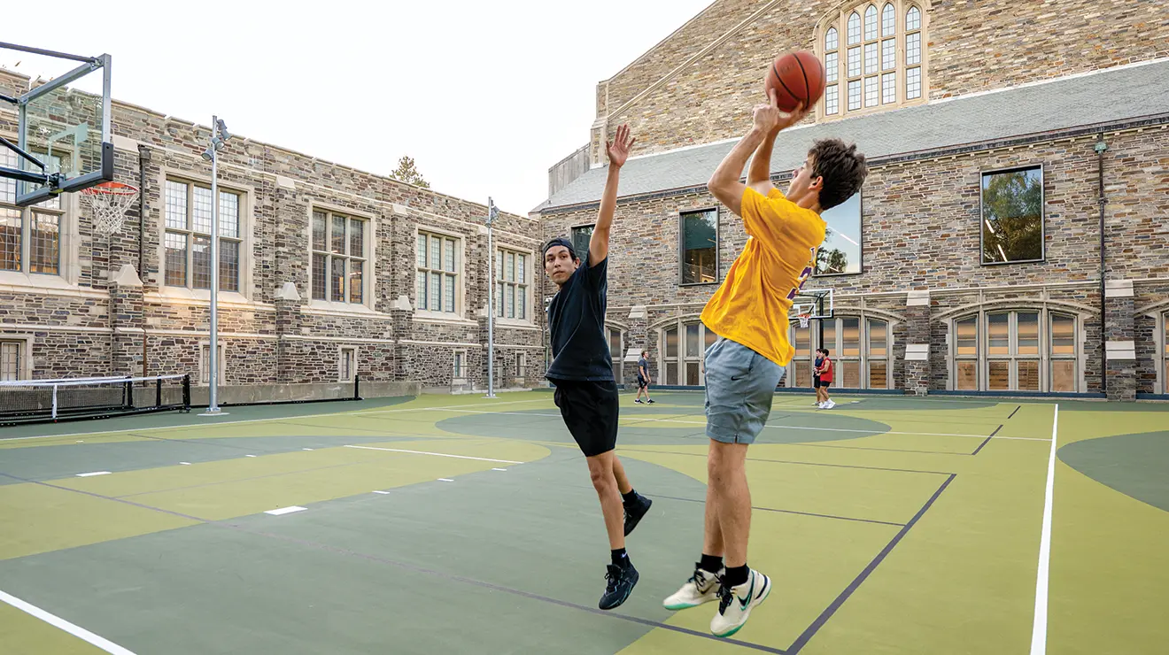 OTC_DillonBasketballCourt_100225_0002 copy.png Two people playing basketball on an outdoor court