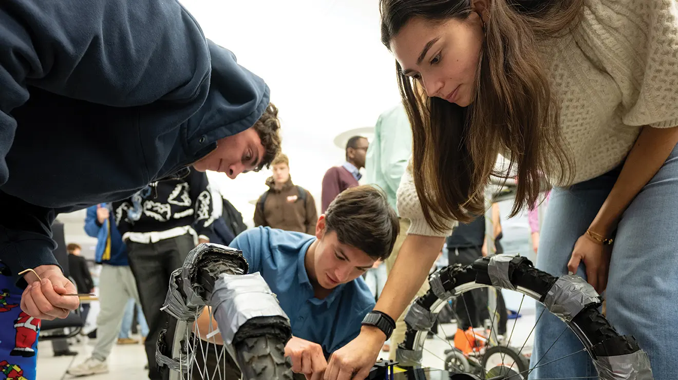 OTC_MAE-RobotPresentations_121525_0008 copy.jpg From left, Lucas Denault ’27, Arthur Balva ’27, and Ani Kozak ’27, students in MAE 322: Mechanical Design, prepare their autonomous vehicle to navigate a “search-and-rescue” course during the class’s final presentations Dec. 15.