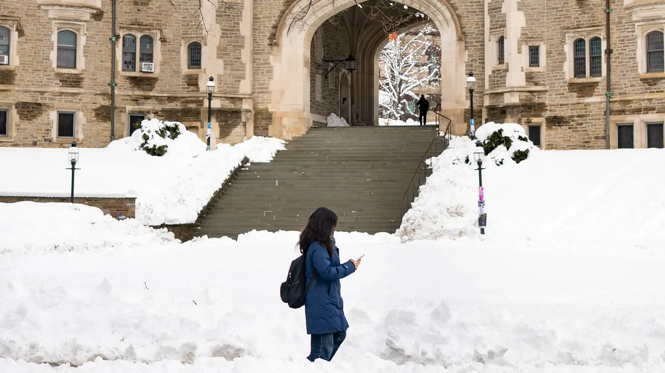 BLIZZARD_Blue coat.jpg Student in blue coat walks past Blair Arch after the blizzard.