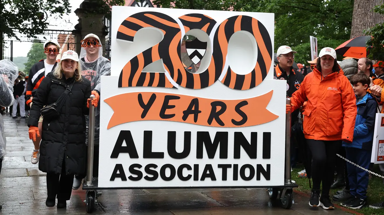 PRADE_200 Sign NEW_Bev.jpg People carry a sign in the P-rade reading "200 Years Alumni Association."