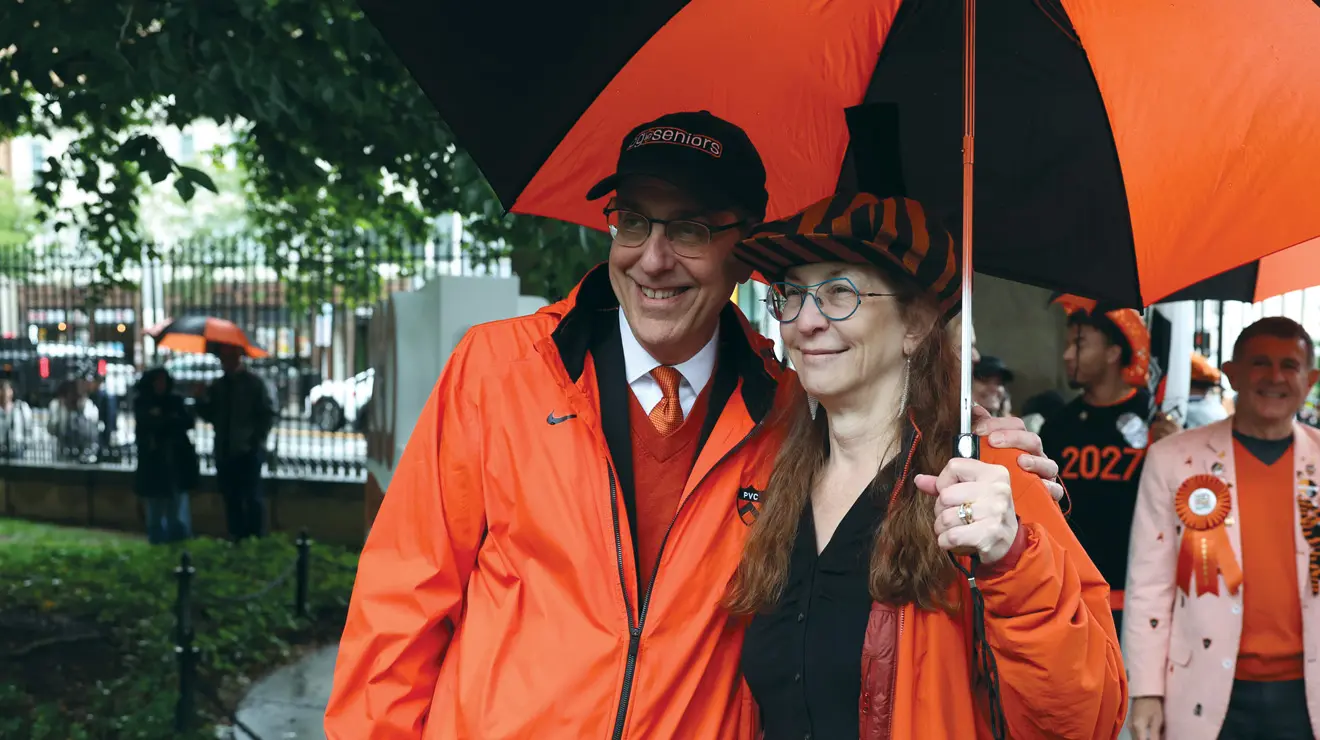 PRADE_Eisgruber and wide_Bev.jpg President Eisgruber and a woman under a black and orange umbrella.