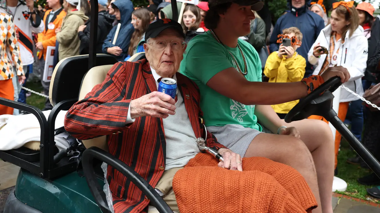 PRADE_Silver cane Golden Beer_Bev.jpg A man holds a beer as he rides in a golf cart.
