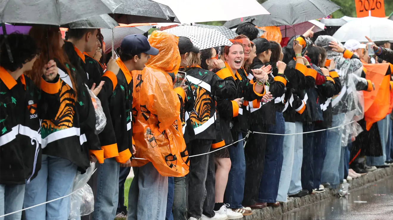 PRADE_Wet Revellers_Kevin Birch.jpg People in Reunions gear line the P-rade route behind a rope.
